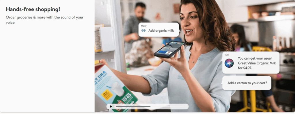 A woman uses a smartphone with voice-activated shopping to add organic milk to her Walmart cart, showcasing the e-commerce trend of voice commerce